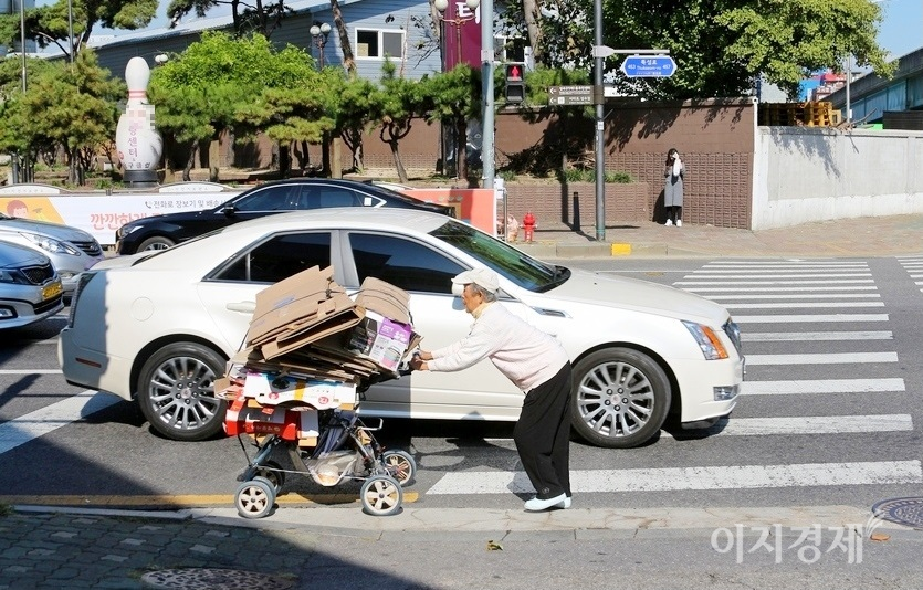 지난해 가을, 한 노인이 서울 영동대교 북단 뚝섬로에서 카트에 폐지를 싣고 역주행하고 있다. 사진=정수남 기자