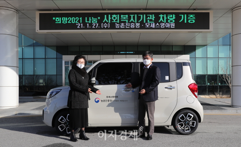 허태웅(오른쪽) 농촌진흥청장이 27일 전북 전주시 농진청 본청에서 직원들이 모금한 성금으로 구입한 차량을 사회복지시설 '모세스영아원' 원장에게 전달한 뒤 기념촬영을 하고 있다. 사진=농촌진흥청