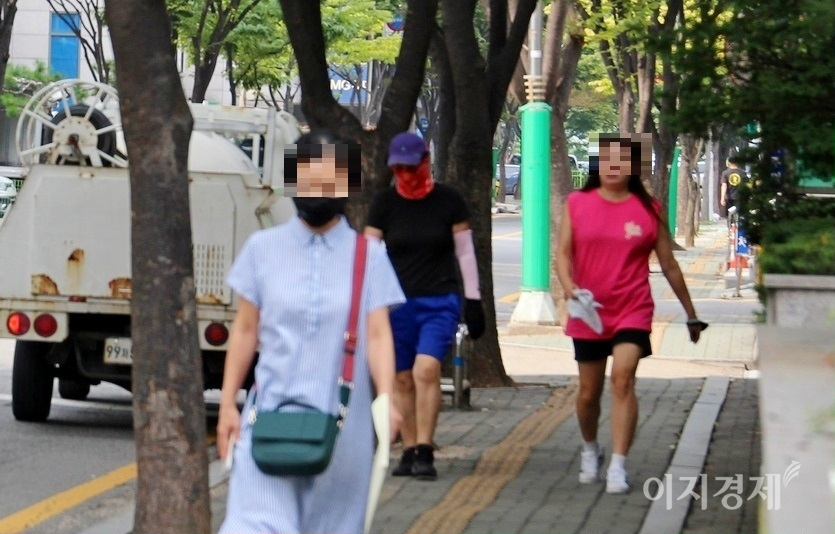 50대로 보이는 여성도 마스크 없이 인도를 활개하고 있다. 사진=정수남기자