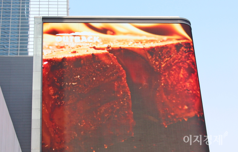 아웃백의 또 다른 주력인 티본 스테이크. bhc가 인수 후 삼성동 SM타운 외벽 LCD 광고 판에서 아웃백 홍보를 시작했다. 사진=정윤서 기자