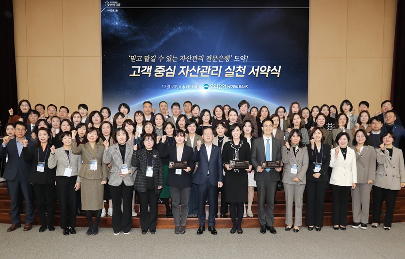 조병규 은행장(첫번째줄 왼쪽 8번째), 김범석 국내영업 부문장(첫번째줄 왼쪽 첫번째), 송현주 자산관리 그룹장(첫번째줄 오른쪽 3번째)과 임직원들이 기념 사진을 촬영하고 있다. 사진=우리은행